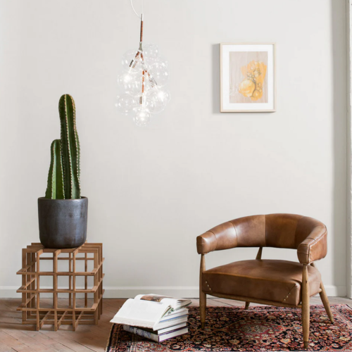 Airy. Playful. Iconic. A sculptural statement that feels both weightless and bold. Crafted from blown glass and wrapped in leather cords, this design floats like a dream and glows with purpose.  More than a chandelier. It’s poetry in light.
